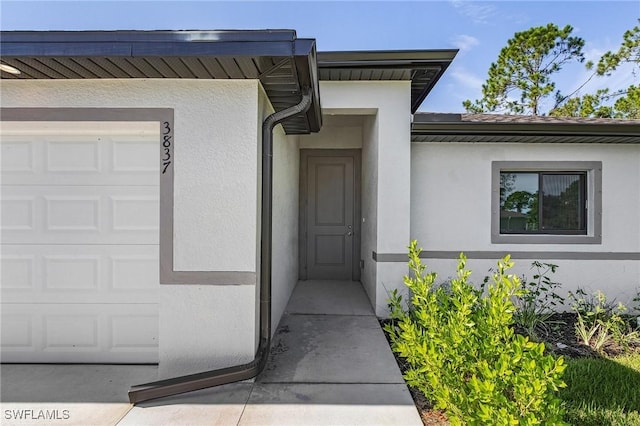 view of exterior entry featuring a garage