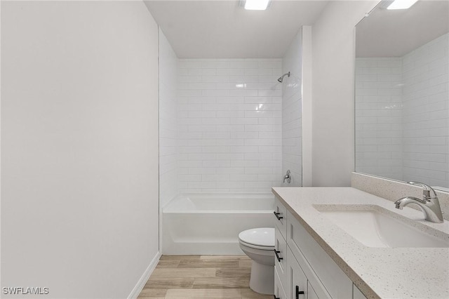 full bathroom with wood-type flooring, vanity, toilet, and tiled shower / bath combo