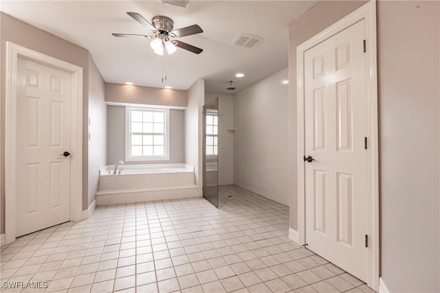 bathroom with ceiling fan, tile patterned flooring, and plus walk in shower