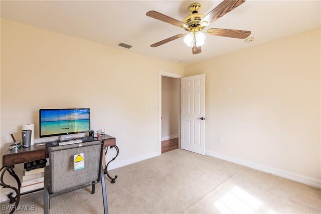 office space with ceiling fan and light colored carpet