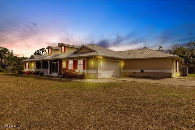 exterior space featuring a garage and a lawn