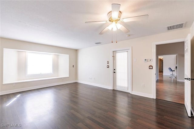 spare room featuring ceiling fan and dark hardwood / wood-style flooring