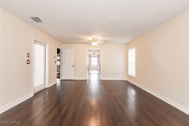 unfurnished room featuring dark wood-type flooring and ceiling fan