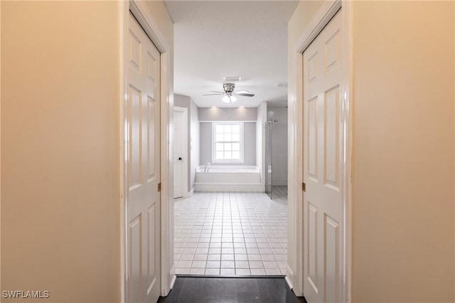 corridor with wood-type flooring