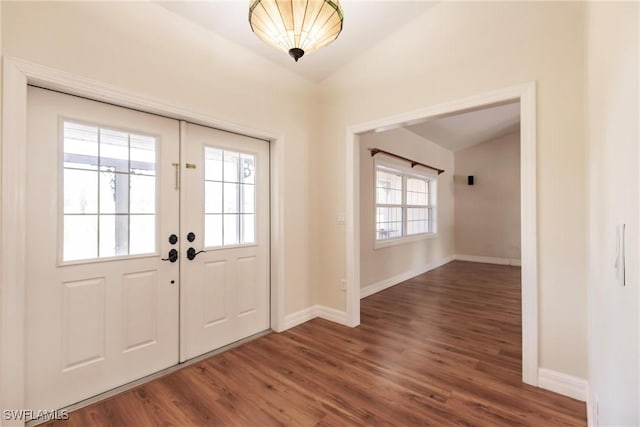 entryway featuring a wealth of natural light, dark hardwood / wood-style flooring, lofted ceiling, and french doors