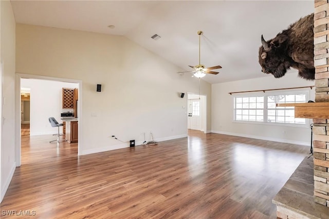 unfurnished living room with ceiling fan, dark wood-type flooring, and high vaulted ceiling