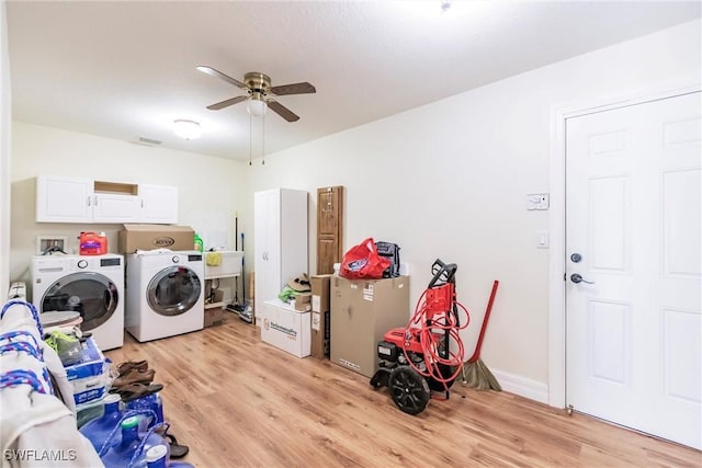 laundry room featuring separate washer and dryer, cabinets, light hardwood / wood-style floors, sink, and ceiling fan