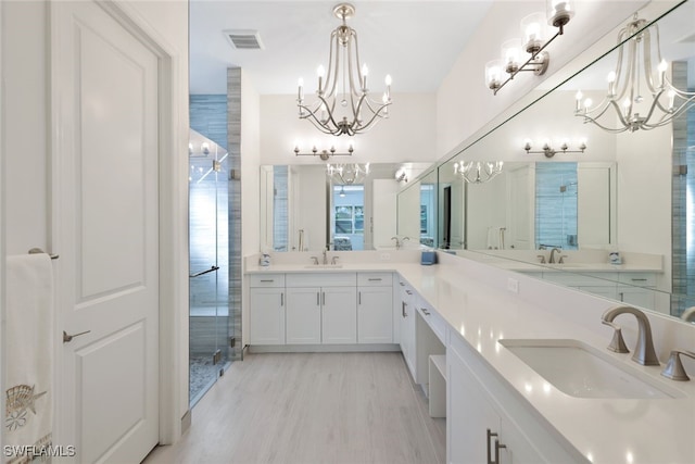 bathroom featuring vanity, wood-type flooring, and walk in shower