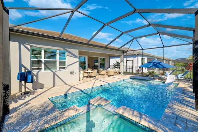 view of swimming pool with a lanai and a patio area