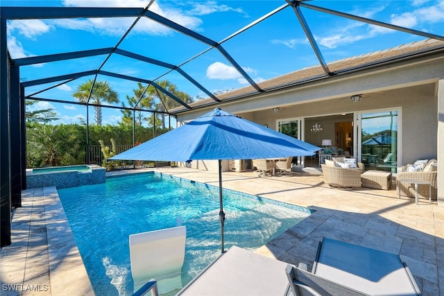 view of pool featuring glass enclosure, an in ground hot tub, ceiling fan, and a patio