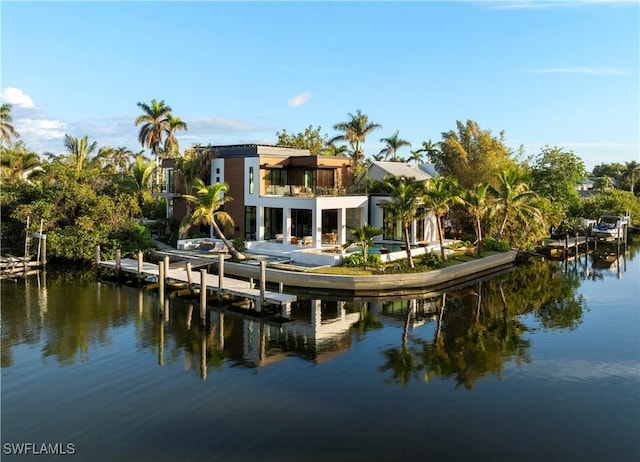 back of property featuring a water view and a balcony