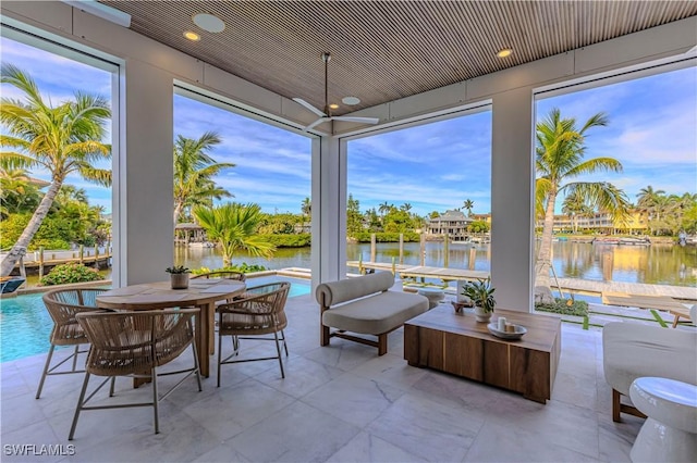 sunroom / solarium featuring a water view and recessed lighting