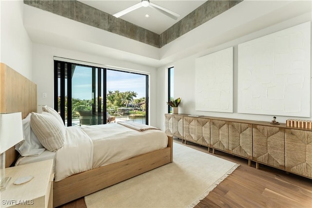 bedroom featuring access to outside and wood finished floors