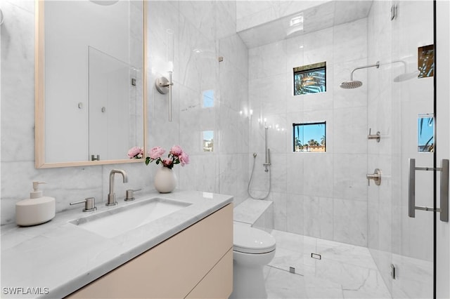 bathroom featuring a shower stall, toilet, and vanity