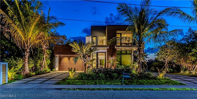 view of front of home with a balcony and driveway
