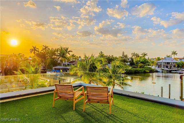 dock area featuring a water view and a yard