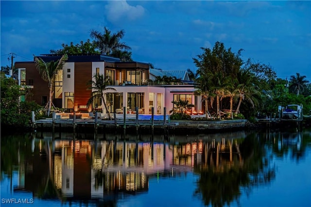 rear view of house featuring a water view