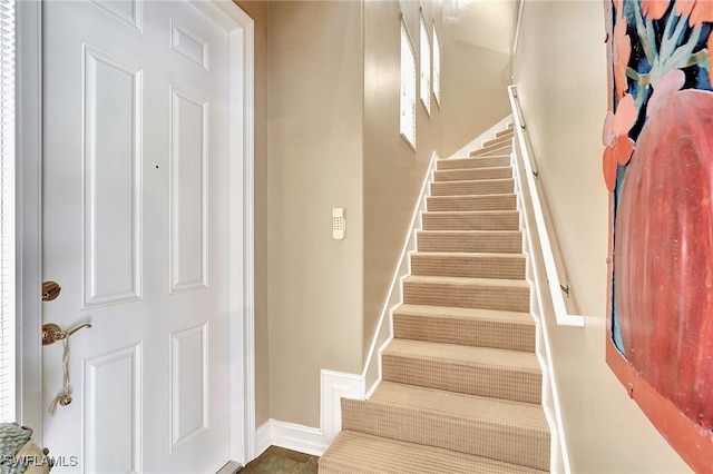 stairs featuring baseboards