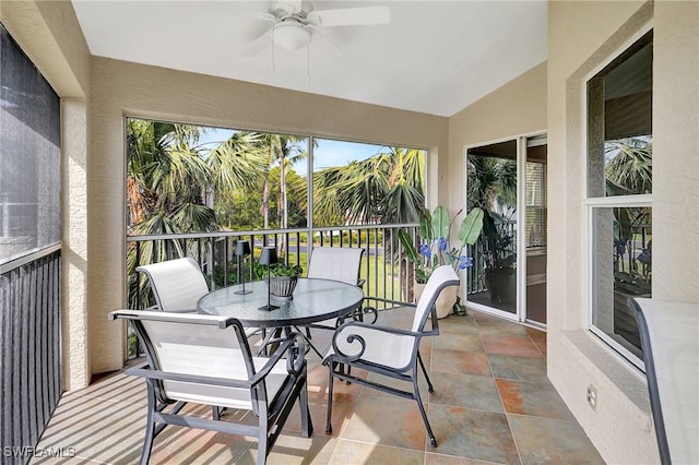 sunroom / solarium featuring a ceiling fan and vaulted ceiling