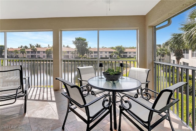 sunroom with a residential view and a healthy amount of sunlight