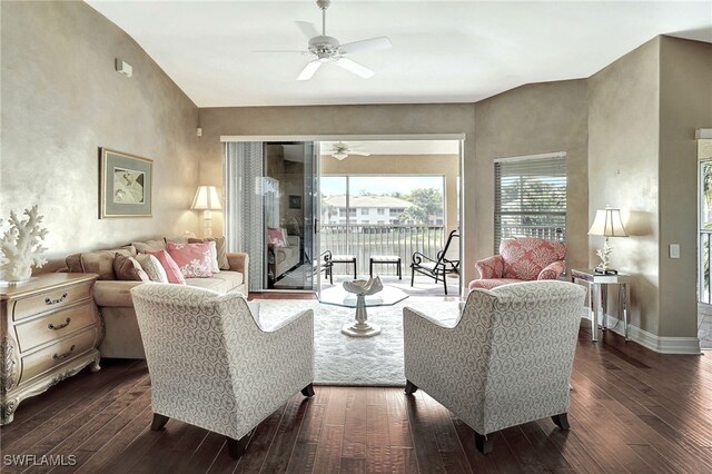 living room featuring ceiling fan and dark hardwood / wood-style flooring