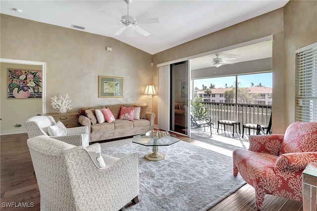 living area featuring a ceiling fan, wood finished floors, visible vents, baseboards, and vaulted ceiling