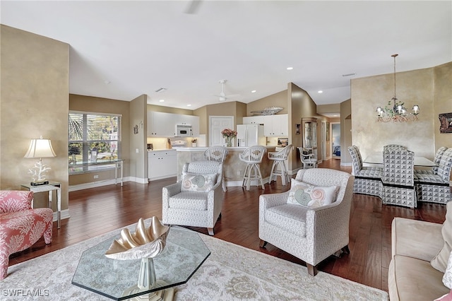 living room with dark hardwood / wood-style floors, lofted ceiling, and ceiling fan with notable chandelier