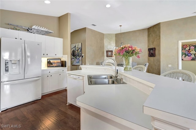 kitchen with light countertops, dark wood-style floors, white appliances, white cabinetry, and a sink