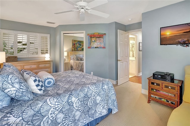 bedroom with a ceiling fan, light colored carpet, visible vents, and baseboards