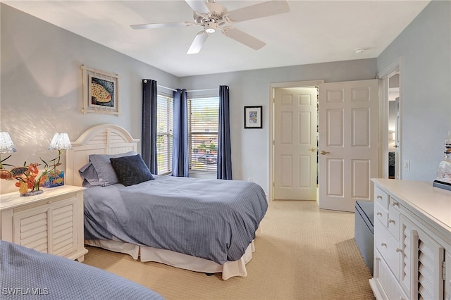 bedroom with light colored carpet and a ceiling fan