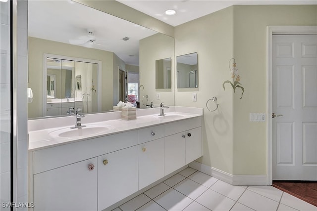 bathroom with tile patterned flooring, vanity, and ceiling fan