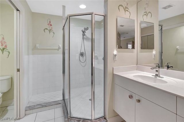 full bathroom with visible vents, toilet, a stall shower, and vanity