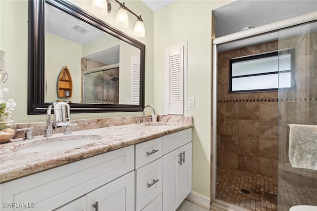 bathroom with vanity and a shower with shower door