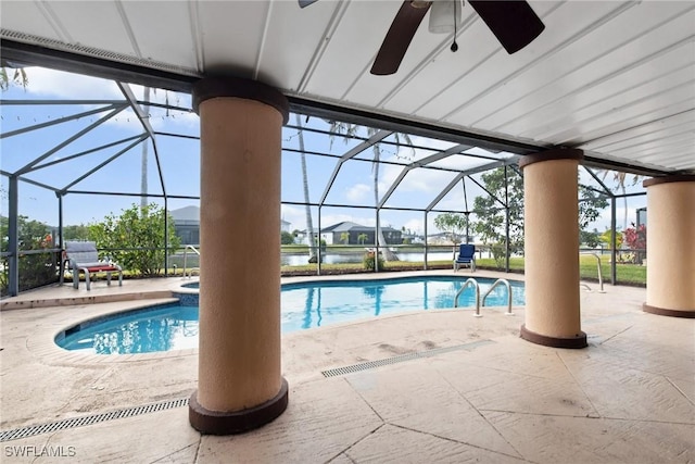 view of swimming pool featuring glass enclosure, ceiling fan, and a patio area