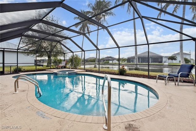 view of pool with glass enclosure, a patio area, a water view, and an in ground hot tub