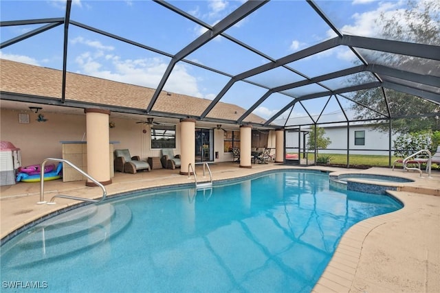 view of swimming pool featuring outdoor lounge area, glass enclosure, ceiling fan, an in ground hot tub, and a patio area