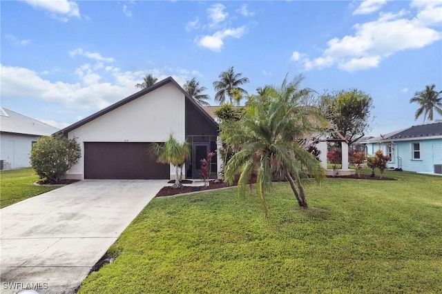 view of front of home featuring a front yard and a garage