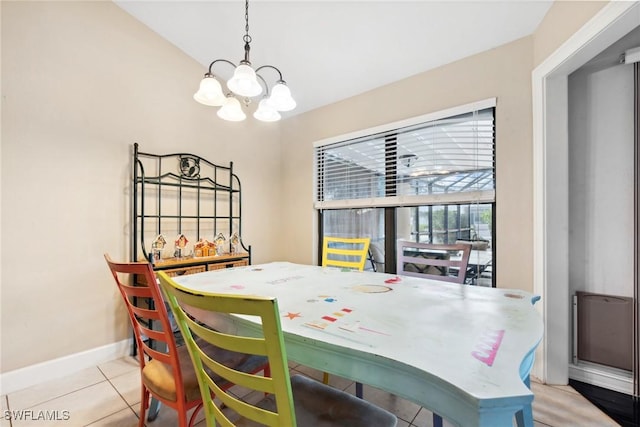 dining area featuring a notable chandelier and light tile patterned floors