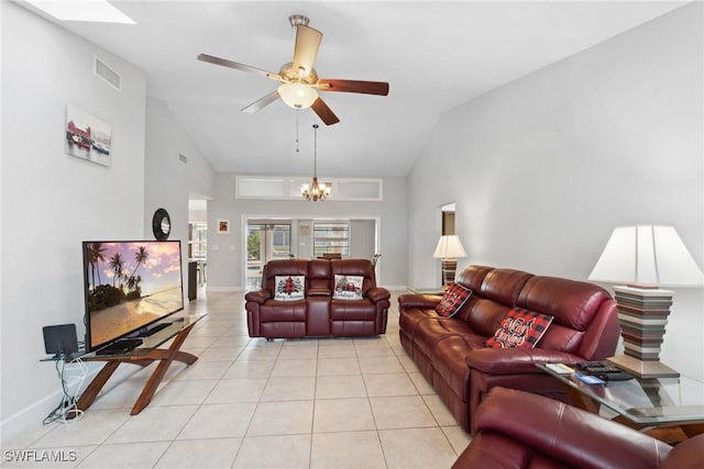 tiled living room featuring ceiling fan with notable chandelier and vaulted ceiling