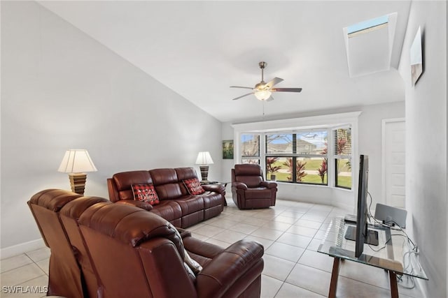 tiled living room with ceiling fan and vaulted ceiling