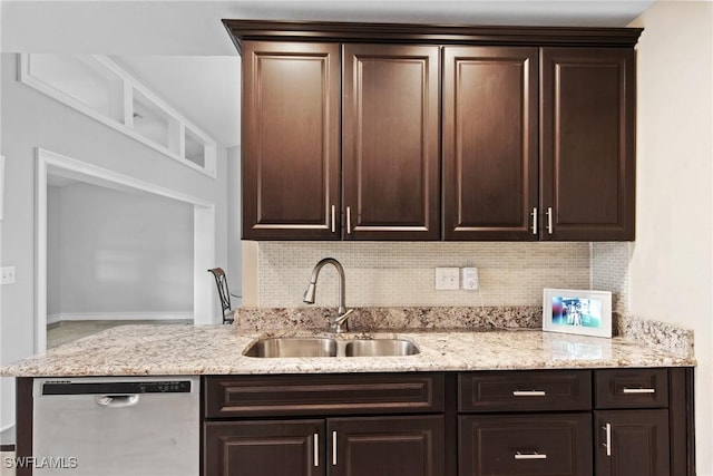 kitchen featuring backsplash, dishwasher, dark brown cabinets, and sink