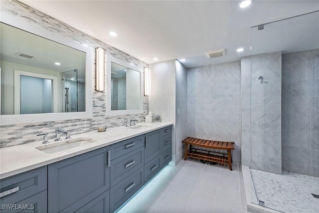 bathroom featuring tile patterned floors, a shower, vanity, and tile walls