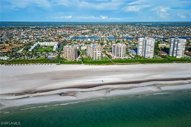 bird's eye view featuring a water view and a view of the beach