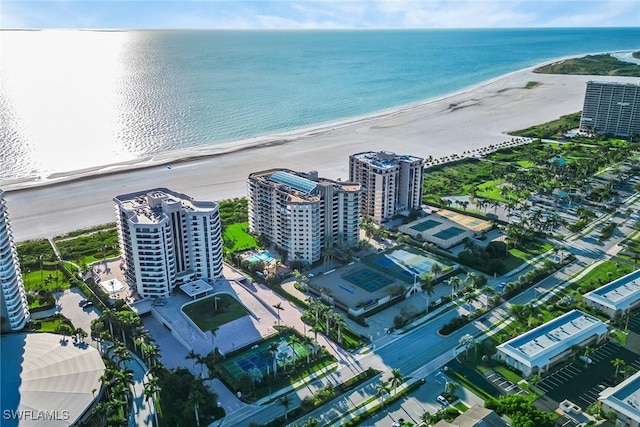 birds eye view of property with a water view and a view of the beach