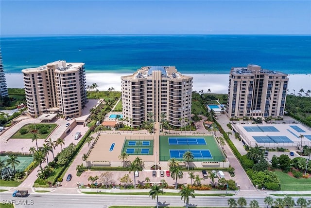 drone / aerial view featuring a water view and a view of the beach