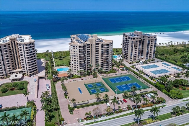 bird's eye view featuring a water view and a beach view