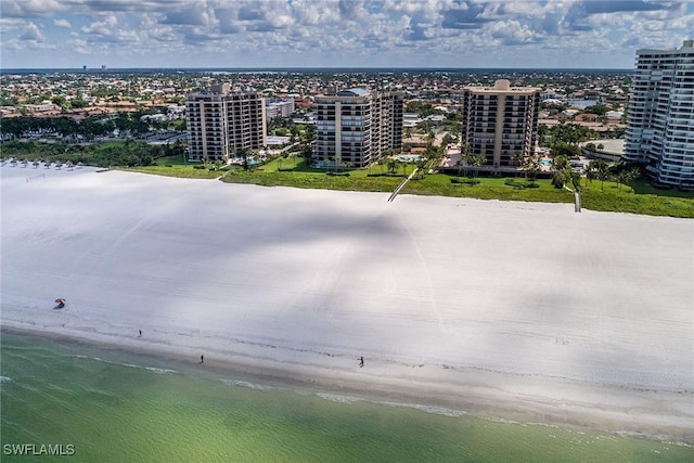 birds eye view of property featuring a water view and a view of the beach