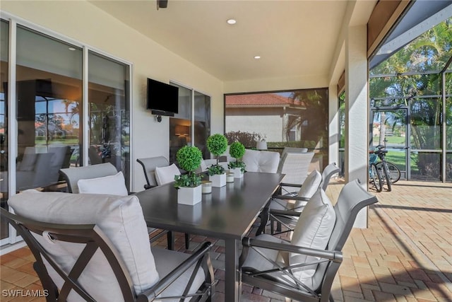 view of patio / terrace featuring glass enclosure