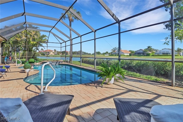 view of swimming pool featuring a lanai, a patio area, and a water view