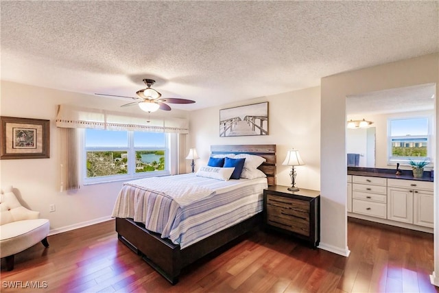 bedroom featuring a textured ceiling, dark hardwood / wood-style flooring, and ceiling fan